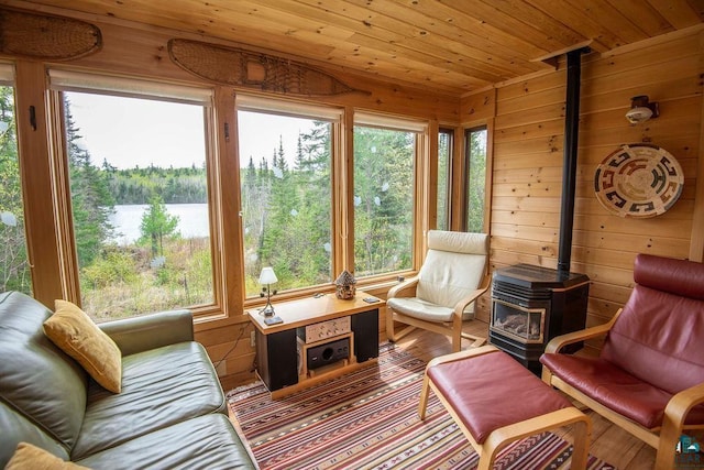 258 Soderberg Ln, Grand Marais, MN 55604 - sunroom with a wood stove, wood ceiling, wood walls, and wood finished floors