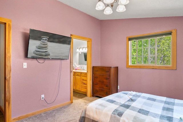 4527 Vermilion Trl, Gilbert, MN 55741 - carpeted bedroom featuring a chandelier, a sink, ensuite bath, and baseboards