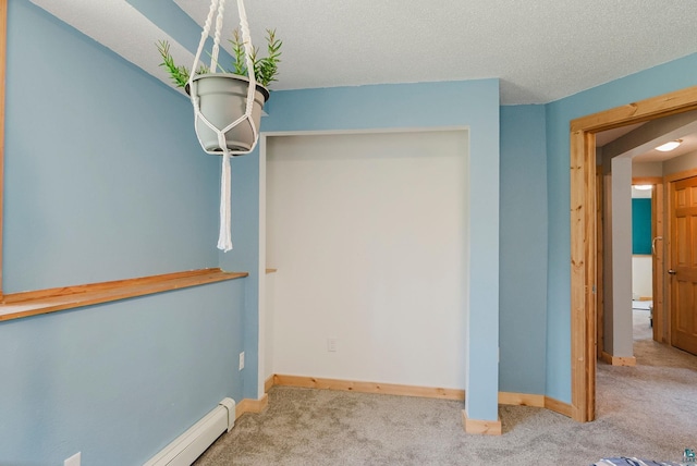4527 Vermilion Trl, Gilbert, MN 55741 - empty room featuring carpet, baseboards, a textured ceiling, and a baseboard heating unit