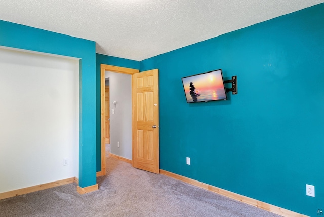 4527 Vermilion Trl, Gilbert, MN 55741 - unfurnished bedroom with baseboards, carpet flooring, and a textured ceiling