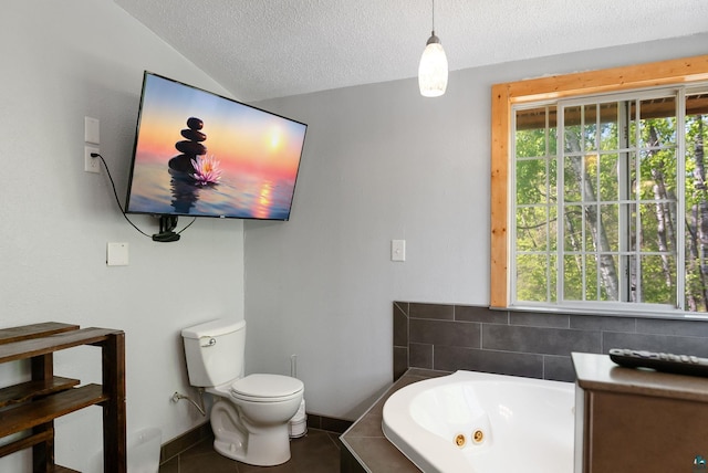 4527 Vermilion Trl, Gilbert, MN 55741 - full bathroom with a tub with jets, toilet, a textured ceiling, baseboards, and lofted ceiling