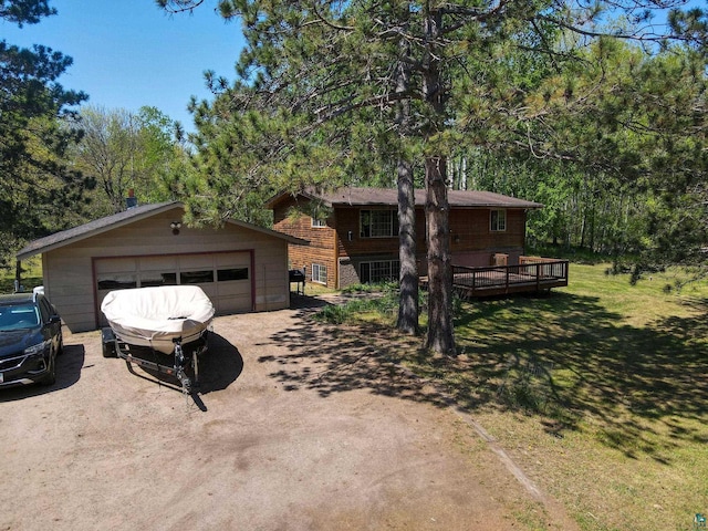 4527 Vermilion Trl, Gilbert, MN 55741 - view of front of house with an outdoor structure, a detached garage, a front yard, and a wooden deck