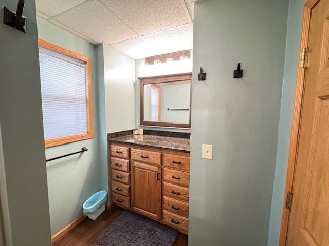 1917 Greysolon Rd, Duluth, MN 55812 - bathroom featuring a paneled ceiling, wood finished floors, vanity, and baseboards