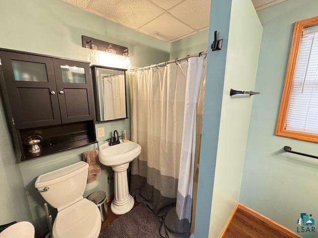 1917 Greysolon Rd, Duluth, MN 55812 - full bath with toilet, a shower with shower curtain, a drop ceiling, and baseboards
