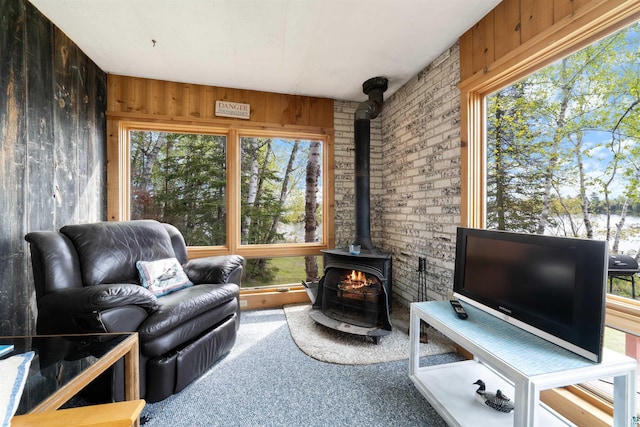 9320 W Branch Rd, Duluth, MN 55803 - sunroom / solarium featuring a wood stove and healthy amount of natural light