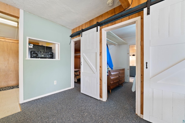 9320 W Branch Rd, Duluth, MN 55803 - unfurnished bedroom featuring a barn door and carpet floors