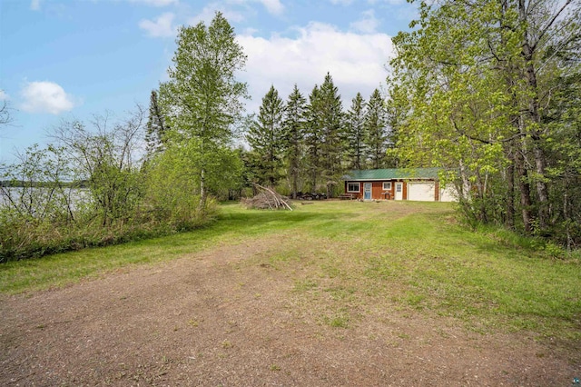 9320 W Branch Rd, Duluth, MN 55803 - view of green lawn with a garage and driveway