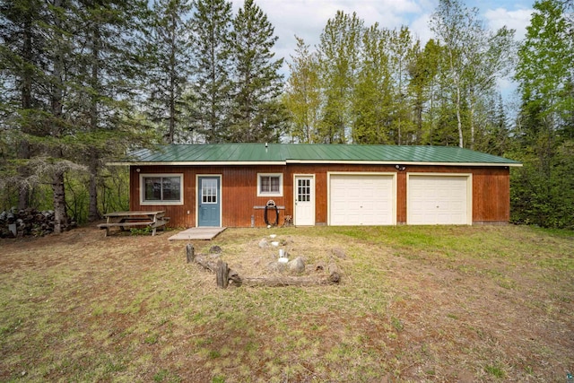 9320 W Branch Rd, Duluth, MN 55803 - view of front of home with metal roof, driveway, view of scattered trees, and a front yard