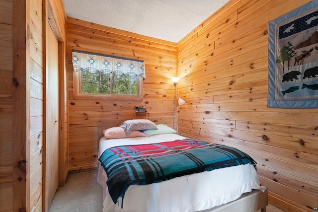 9320 W Branch Rd, Duluth, MN 55803 - bedroom featuring wooden walls and concrete flooring
