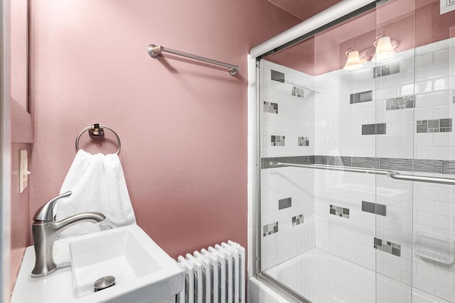 619 W Skyline Pkwy, Duluth, MN 55806 - bathroom with radiator, shower / bath combination with glass door, and a sink