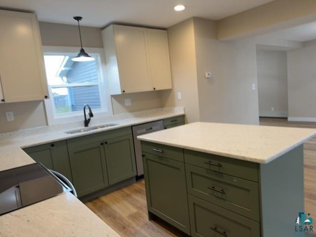 402 N Elba Ave, Eveleth, MN 55734 - kitchen with a sink, green cabinetry, dishwasher, light wood-style floors, and recessed lighting