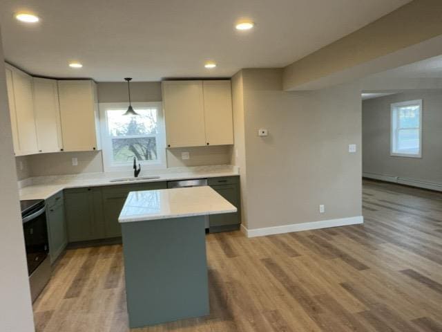 402 N Elba Ave, Eveleth, MN 55734 - kitchen featuring a sink, stainless steel electric stove, light countertops, baseboards, and light wood finished floors