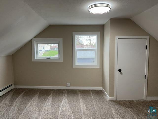 402 N Elba Ave, Eveleth, MN 55734 - additional living space with carpet, vaulted ceiling, a baseboard radiator, and baseboards