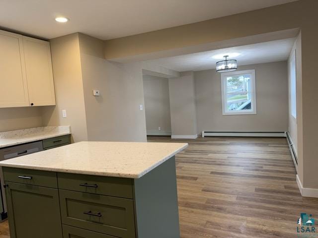 402 N Elba Ave, Eveleth, MN 55734 - kitchen featuring a kitchen island, baseboard heating, light wood-style flooring, baseboards, and recessed lighting