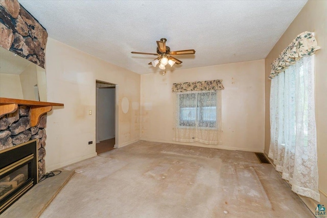997 85th Ave W, Duluth, MN 55808 - unfurnished living room with a ceiling fan, a fireplace, baseboards, and a textured ceiling