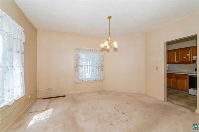 997 85th Ave W, Duluth, MN 55808 - unfurnished dining area with a chandelier, light carpet, and baseboards