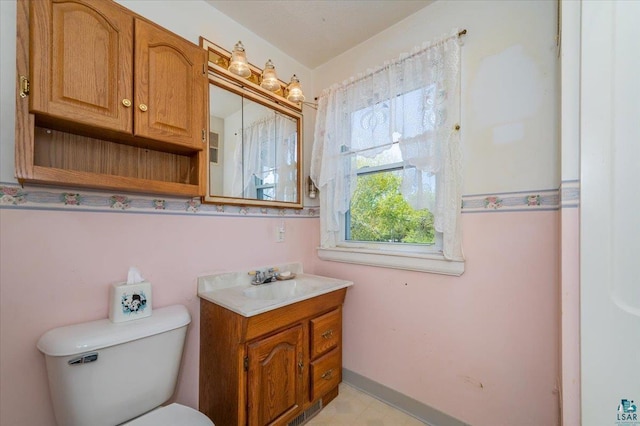 997 85th Ave W, Duluth, MN 55808 - bathroom with vanity, toilet, and baseboards