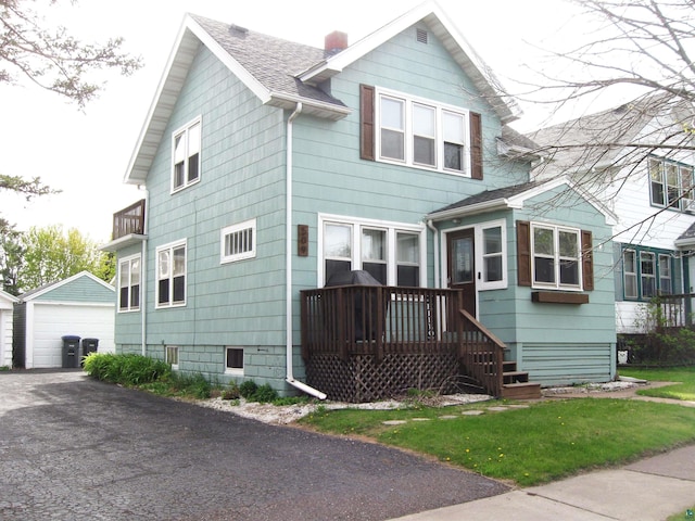 509 N 47th Ave W, Duluth, MN 55807 - view of front of home with an outbuilding, a detached garage, a shingled roof, and a chimney
