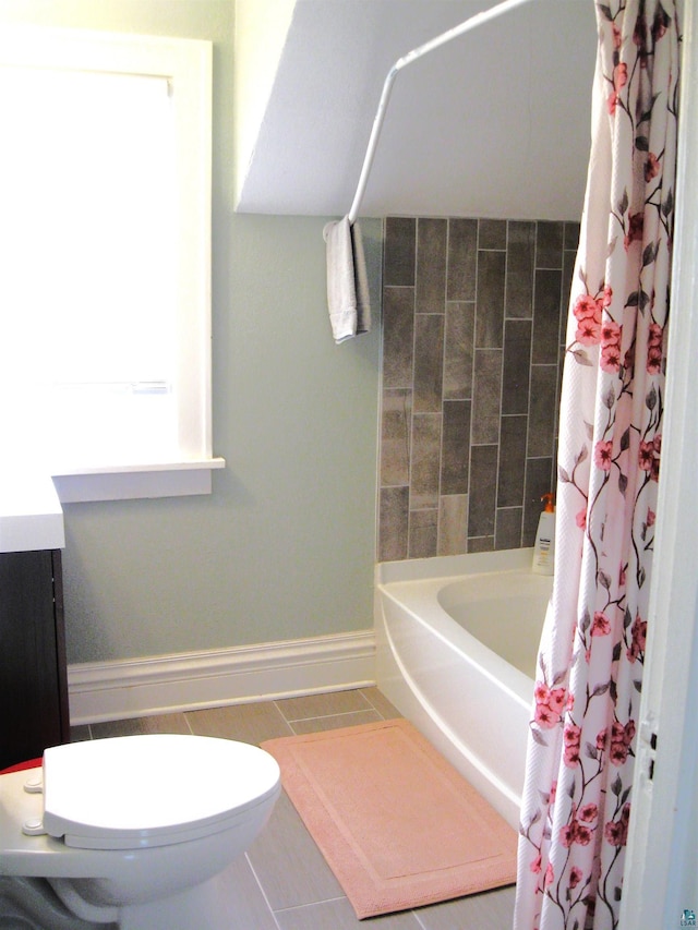 509 N 47th Ave W, Duluth, MN 55807 - full bathroom with baseboards, vanity, shower / bath combo with shower curtain, toilet, and tile patterned flooring