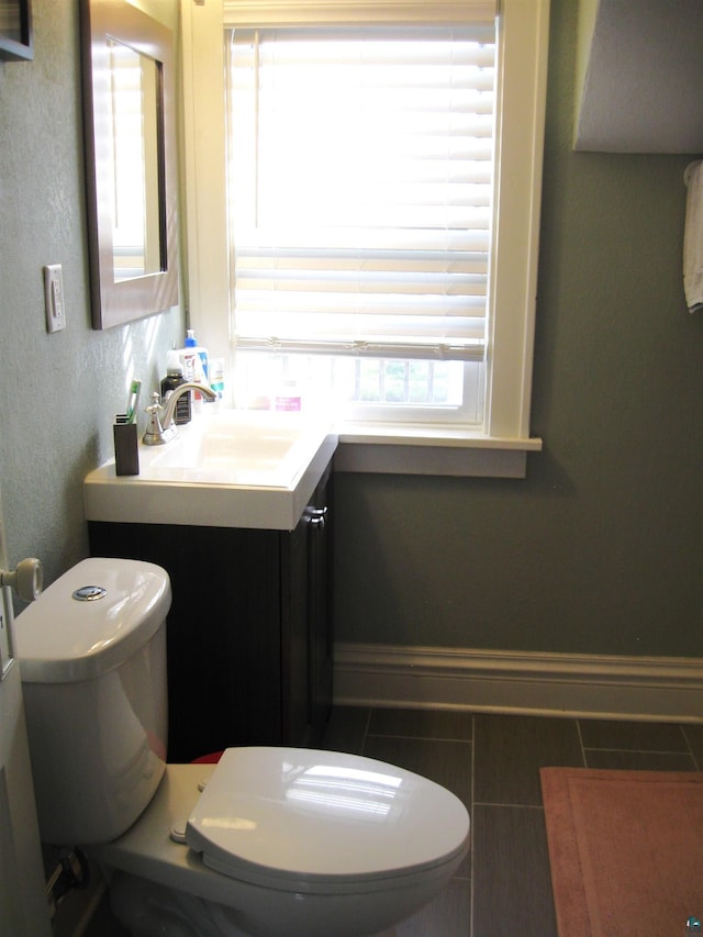 509 N 47th Ave W, Duluth, MN 55807 - bathroom with toilet, vanity, and baseboards