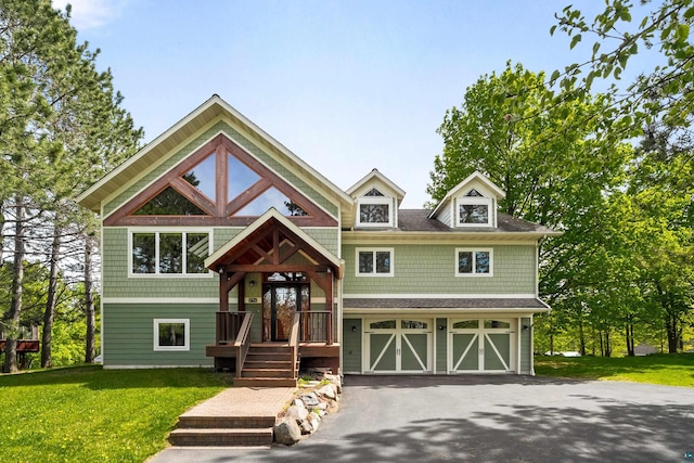 596 W Wabasha St, Duluth, MN 55803 - view of front of house with asphalt driveway, an attached garage, and a front lawn