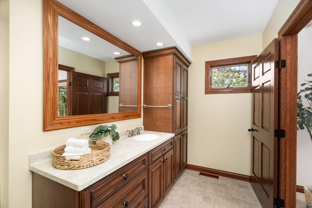 596 W Wabasha St, Duluth, MN 55803 - bathroom featuring vanity, plenty of natural light, baseboards, and recessed lighting