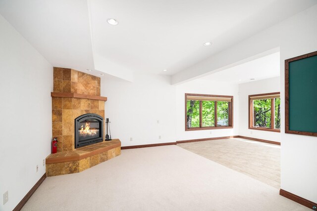 596 W Wabasha St, Duluth, MN 55803 - unfurnished living room with carpet, a tile fireplace, recessed lighting, and baseboards
