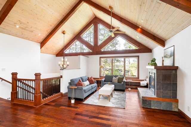 596 W Wabasha St, Duluth, MN 55803 - living area featuring wood-type flooring, a chandelier, a tiled fireplace, wood ceiling with exposed beams, and a ceiling fan
