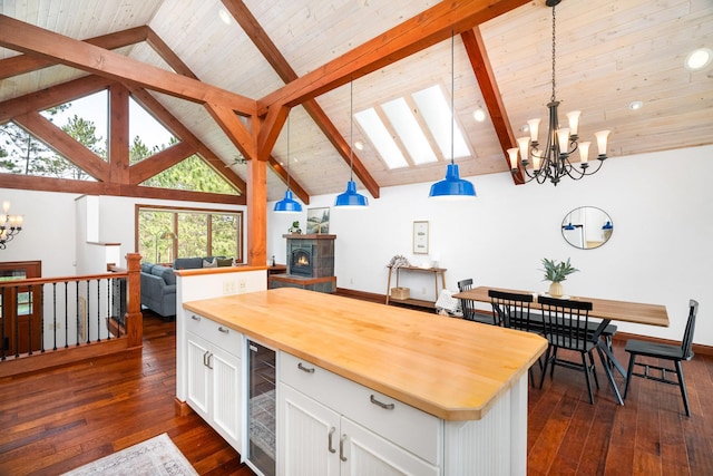 596 W Wabasha St, Duluth, MN 55803 - kitchen featuring a chandelier, butcher block countertops, open floor plan, dark wood-style flooring, and white cabinets