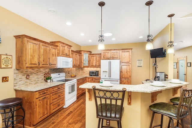 5036 Silver Leaf St, Hermantown, MN 55811 - kitchen with white appliances, a breakfast bar area, dark wood-type flooring, tasteful backsplash, and light stone counters