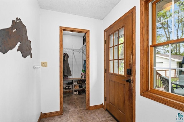 13107 W 9th St, Duluth, MN 55808 - doorway featuring baseboards, a textured ceiling, and light tile patterned flooring