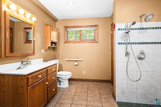 13107 W 9th St, Duluth, MN 55808 - bathroom with vanity, tiled shower, toilet, baseboards, and tile patterned floors