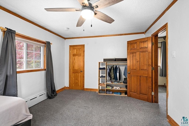 13107 W 9th St, Duluth, MN 55808 - carpeted bedroom featuring baseboard heating, ornamental molding, baseboards, ceiling fan, and a textured ceiling