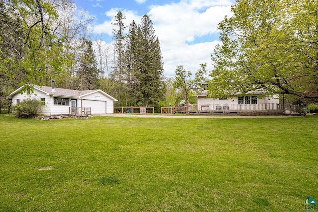 13107 W 9th St, Duluth, MN 55808 - view of green lawn featuring a wooden deck and an attached garage