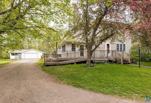 13107 W 9th St, Duluth, MN 55808 - view of front of house with an outbuilding, a wooden deck, a front lawn, dirt driveway, and a detached garage