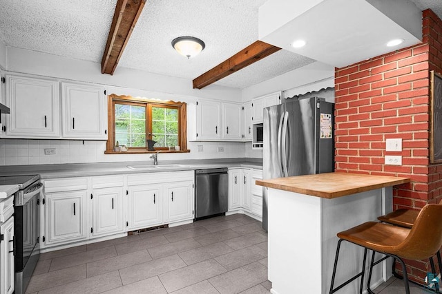 13107 W 9th St, Duluth, MN 55808 - kitchen featuring stainless steel appliances, a sink, wood counters, beam ceiling, and tasteful backsplash