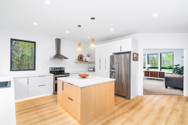 2413 Lismore Rd, Duluth, MN 55804 - kitchen featuring appliances with stainless steel finishes, wall chimney exhaust hood, modern cabinets, light wood-style flooring, and recessed lighting