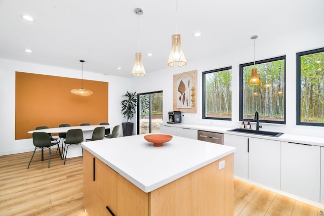 2413 Lismore Rd, Duluth, MN 55804 - kitchen featuring a sink, a center island, recessed lighting, light wood finished floors, and light countertops
