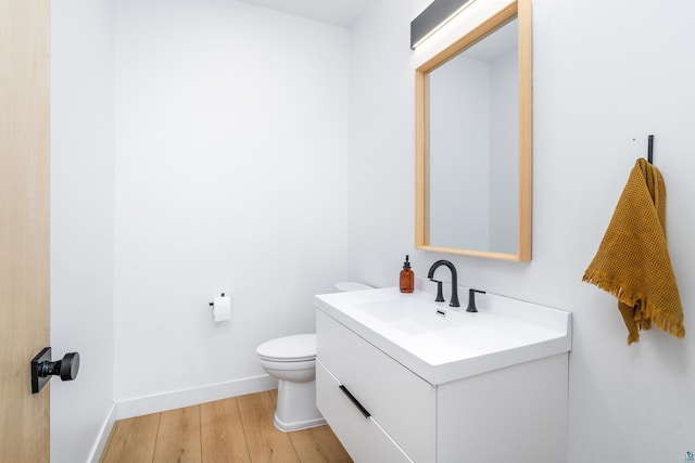 2413 Lismore Rd, Duluth, MN 55804 - bathroom with vanity, wood finished floors, toilet, and baseboards