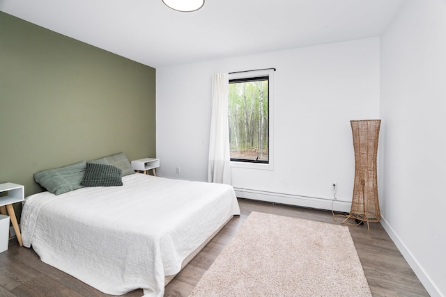 2413 Lismore Rd, Duluth, MN 55804 - bedroom with a baseboard heating unit, wood finished floors, and baseboards