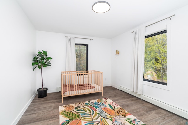 2413 Lismore Rd, Duluth, MN 55804 - bedroom featuring a baseboard heating unit, wood finished floors, and baseboards