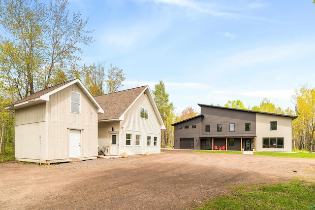 2413 Lismore Rd, Duluth, MN 55804 - view of front facade with an outdoor structure, driveway, and roof with shingles