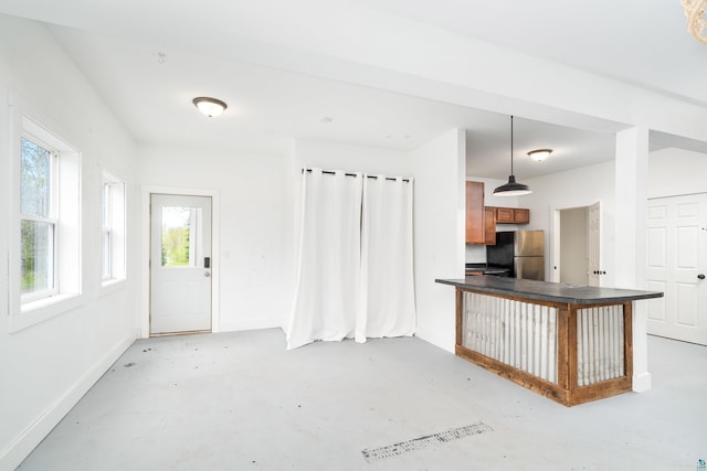 2413 Lismore Rd, Duluth, MN 55804 - kitchen with freestanding refrigerator, concrete flooring, dark countertops, and brown cabinets