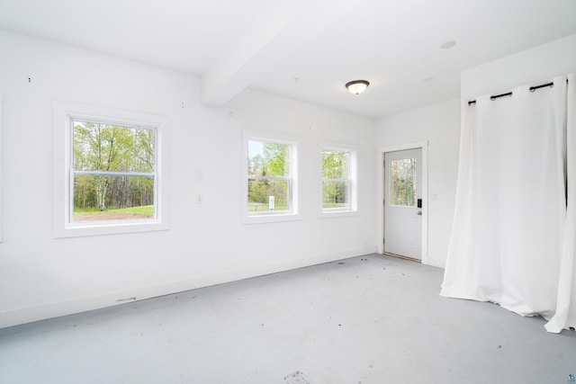 2413 Lismore Rd, Duluth, MN 55804 - spare room with concrete flooring, beam ceiling, and baseboards