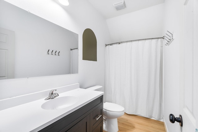 2413 Lismore Rd, Duluth, MN 55804 - bathroom with toilet, vanity, wood finished floors, and a shower with curtain