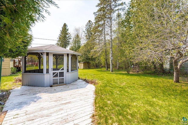 2715 Triggs Ave, Duluth, MN 55811 - wooden deck with a lawn and a sunroom