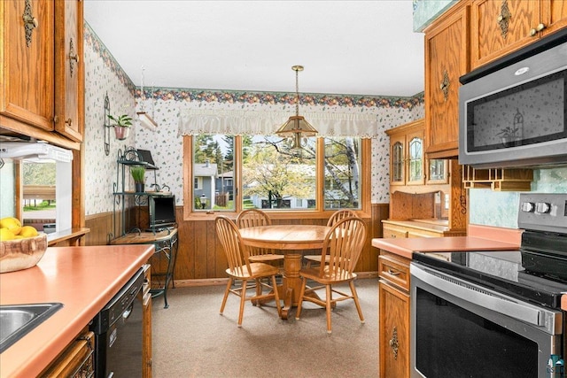 2715 Triggs Ave, Duluth, MN 55811 - kitchen with appliances with stainless steel finishes, wallpapered walls, a wainscoted wall, plenty of natural light, and brown cabinets