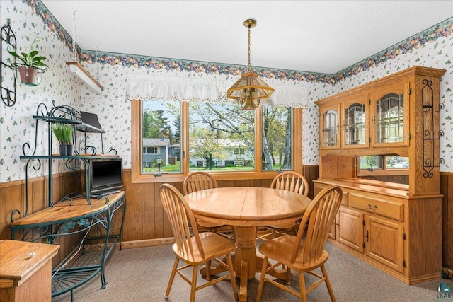 2715 Triggs Ave, Duluth, MN 55811 - dining room featuring wallpapered walls, a wainscoted wall, wooden walls, and a chandelier