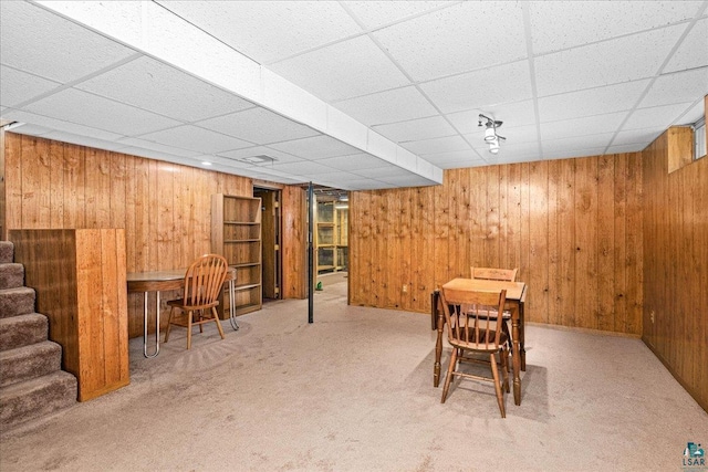 2715 Triggs Ave, Duluth, MN 55811 - dining space with wooden walls, carpet flooring, a paneled ceiling, and stairway