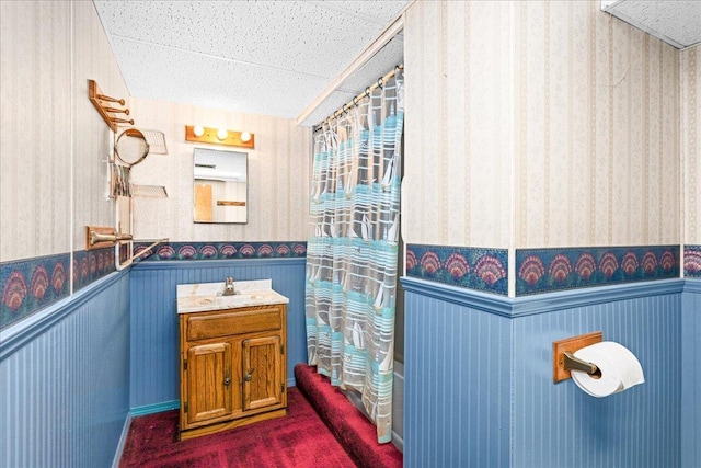 2715 Triggs Ave, Duluth, MN 55811 - full bathroom with wallpapered walls, wainscoting, and vanity